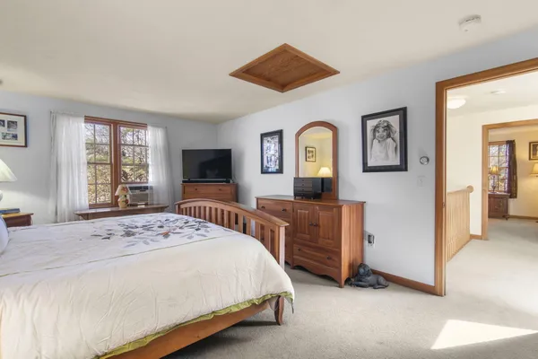 a bedroom with a bed and a dresser