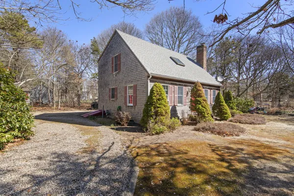 a view of a house with a yard and sitting area