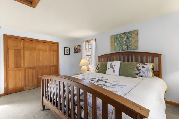 a bed sitting in a bedroom next to a window