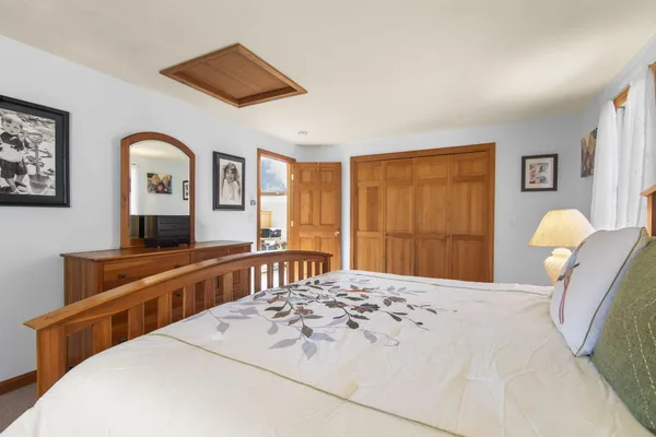 a bedroom with a large bed and a dresser