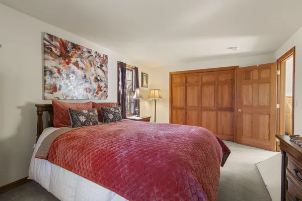 a bed sitting in a bedroom next to a window