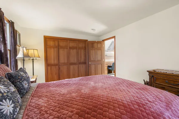 a bedroom with a bed dresser and a window