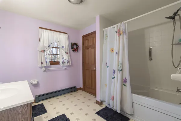 a bathroom with a shower and a sink