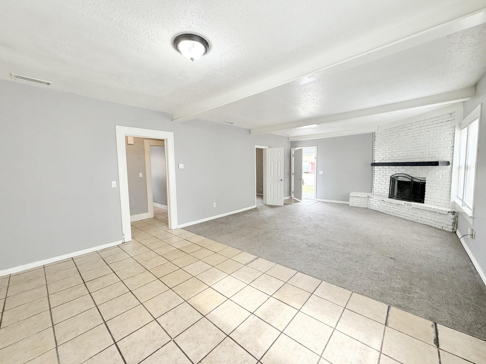 2119 15th Street Lubbock, TX 79401 - Photo 2 of 15 a view of a livingroom with a fireplace