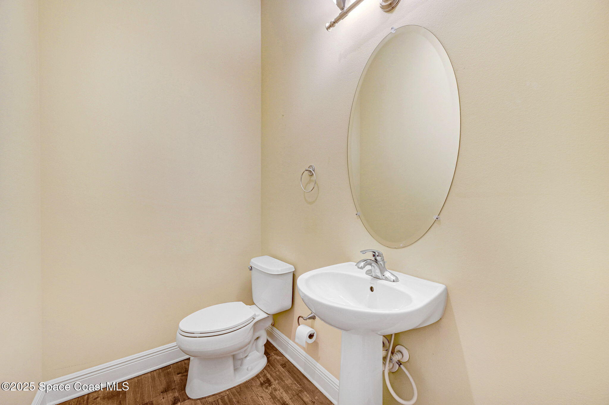 2178 Tanager Court Indialantic, FL 32903 - Photo 25 of 30 a bathroom with a sink a toilet and a mirror