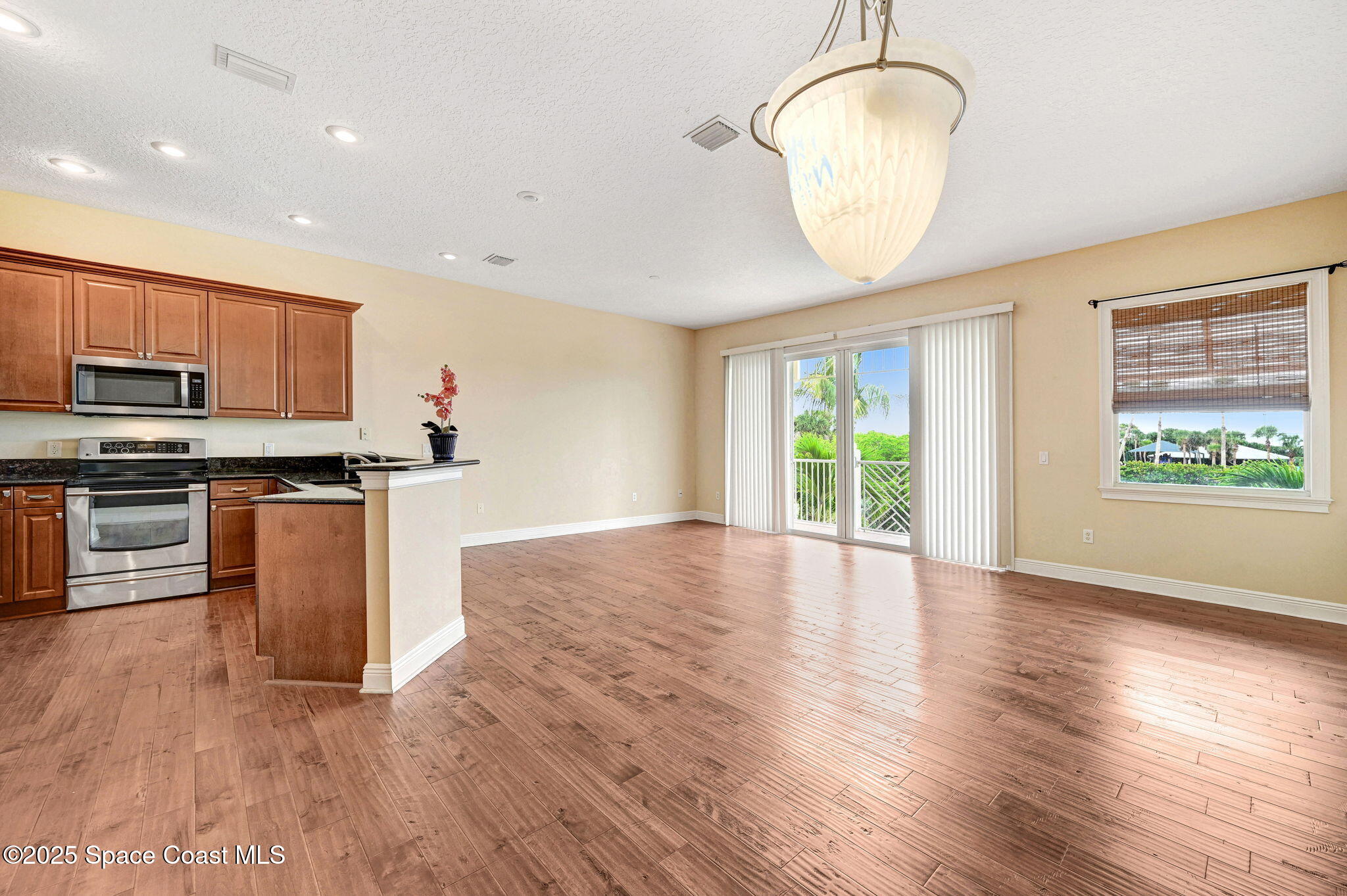 2178 Tanager Court Indialantic, FL 32903 - Photo 9 of 30 a view of kitchen with microwave and wooden floor