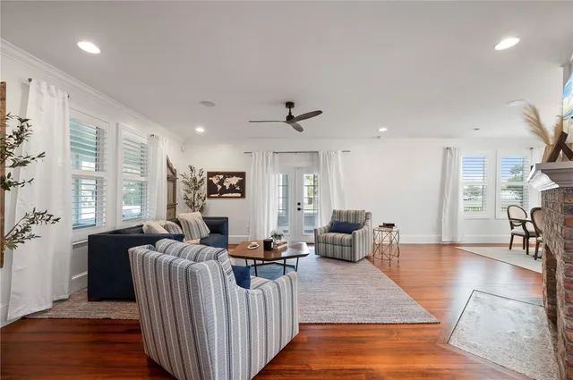 a large kitchen with kitchen island white cabinets and a chandelier