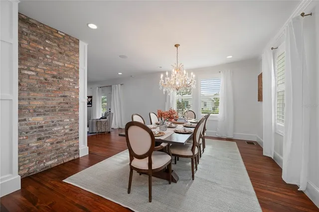 a kitchen with stainless steel appliances a stove and wooden floor