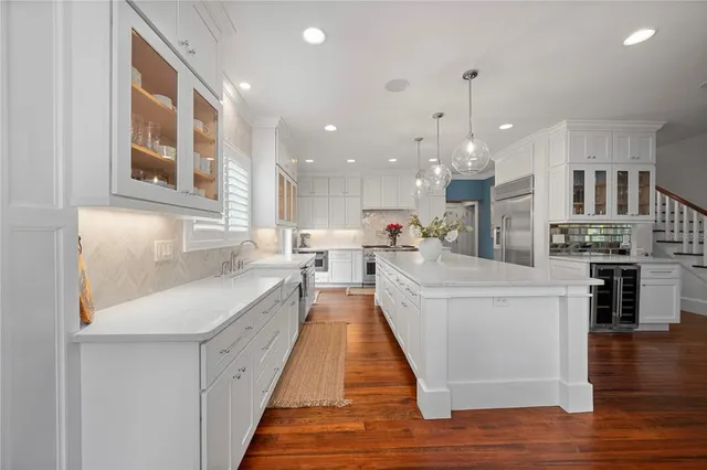 a kitchen with stainless steel appliances granite countertop a refrigerator and a stove top oven