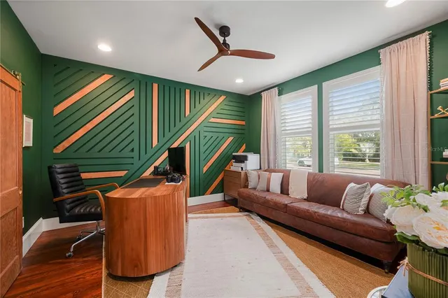 a bedroom with a bed and a large mirror with wooden floor