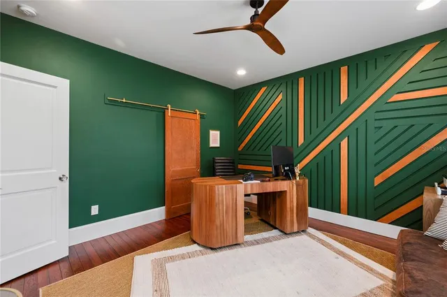 a bedroom with furniture and a flat screen tv
