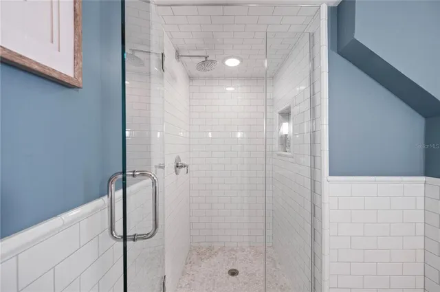 a bathroom with a tub sink and mirror