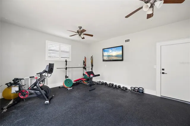 a bedroom with a bed chandelier and a window