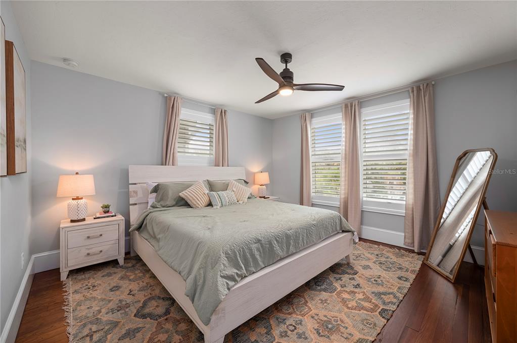 359 Gill Street Punta Gorda, FL 33950 - Photo 49 of 83 a bedroom with a bed and a large mirror with wooden floor