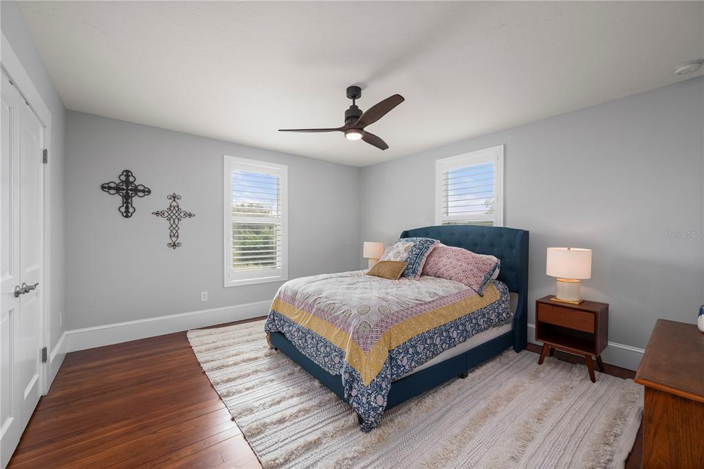 359 Gill Street Punta Gorda, FL 33950 - Photo 57 of 83 a spacious bedroom with a bed and a table in it