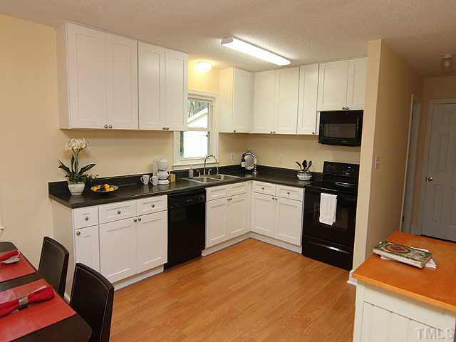2109 Nelson Street Raleigh, NC 27610 - Photo 4 of 20 a kitchen with granite countertop a sink stove and cabinets