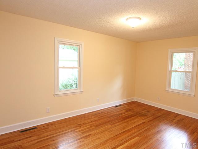 2109 Nelson Street Raleigh, NC 27610 - Photo 6 of 20 an empty room with wooden floor and windows