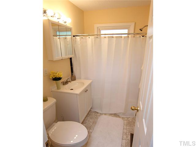 2109 Nelson Street Raleigh, NC 27610 - Photo 7 of 20 a bathroom with a sink a toilet and shower