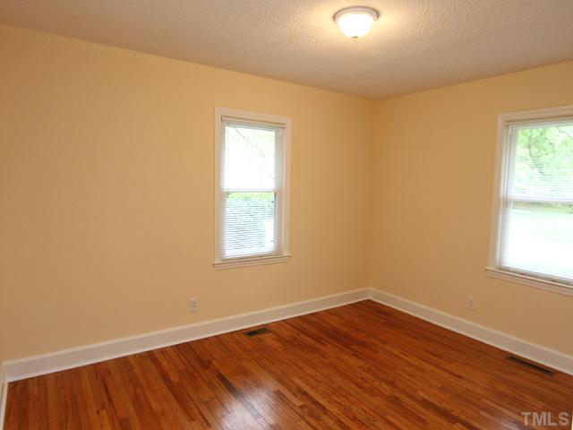 2109 Nelson Street Raleigh, NC 27610 - Photo 9 of 20 an empty room with wooden floor and windows