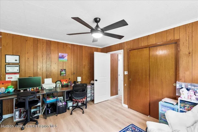 a view of a livingroom with workspace and a window