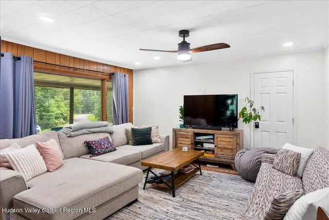 a living room with furniture and a flat screen tv