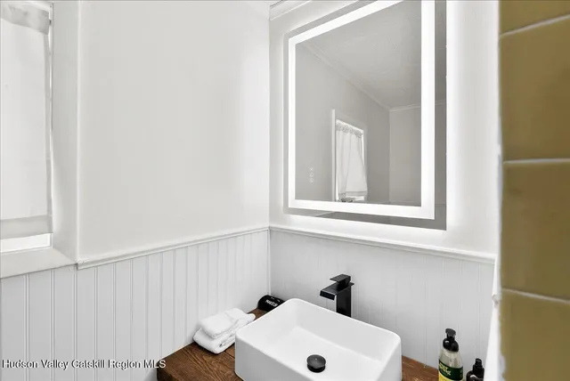 a bathroom with a sink and a window