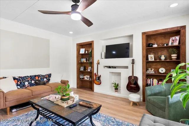 a living room with furniture a rug and a flat screen tv