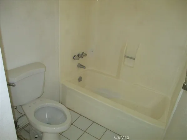 a bathroom with a toilet and a bathtub
