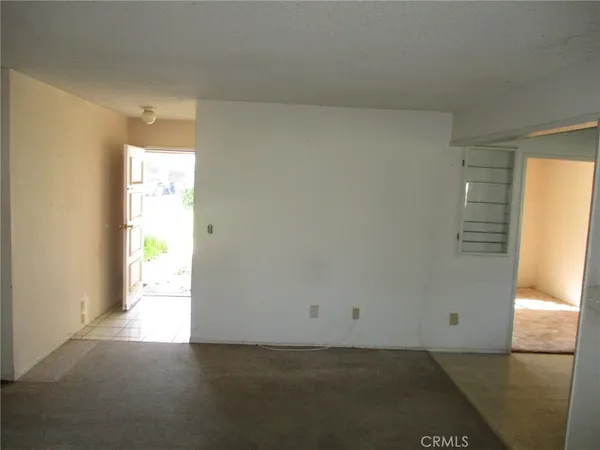 a view of an empty room and a window