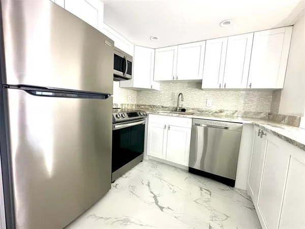 a kitchen with a sink stove and refrigerator