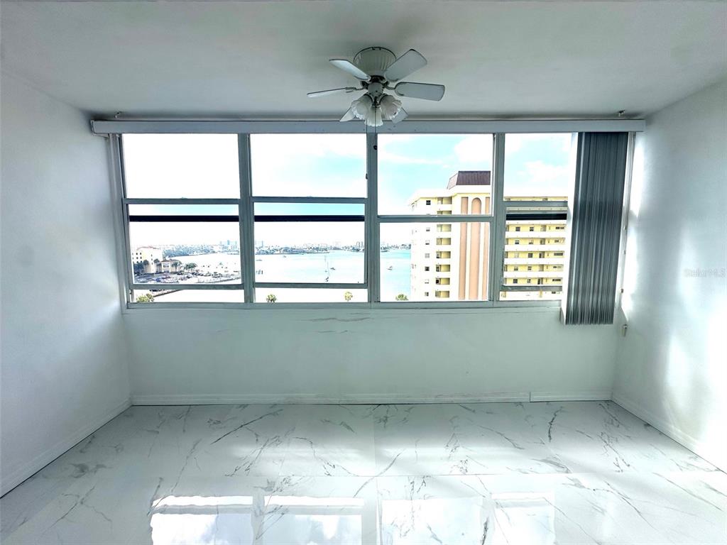 4550 Cove Circle, Unit 905 St. Petersburg, FL 33708 - Photo 6 of 17 an empty room with a window