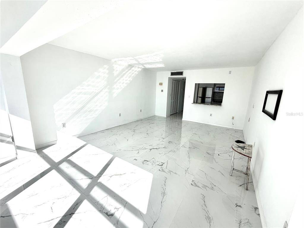 4550 Cove Circle, Unit 905 St. Petersburg, FL 33708 - Photo 7 of 17 a view of a living room with furniture and flat screen tv