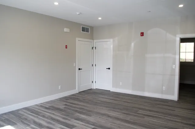 a view of room with wooden floor