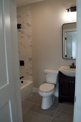 a bathroom with a toilet a sink and shower