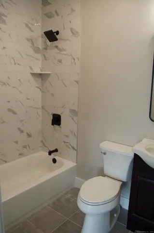 a bathroom with a toilet and a bathtub