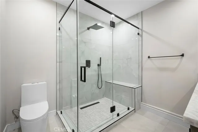 a bathroom with a shower and toilet
