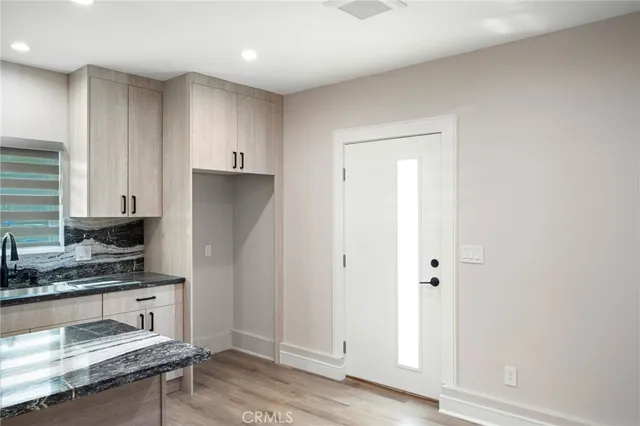 a kitchen with a refrigerator and a stove top oven