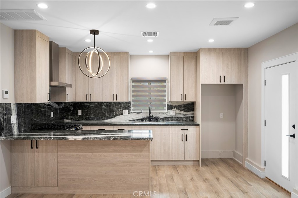 19069 Celtic Street Porter Ranch, CA 91326 - Photo 8 of 17 a kitchen with stainless steel appliances granite countertop a stove a sink and a refrigerator