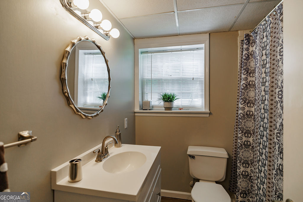226 Baker Street Statham, GA 30666 - Photo 13 of 55 a bathroom with a toilet sink and mirror