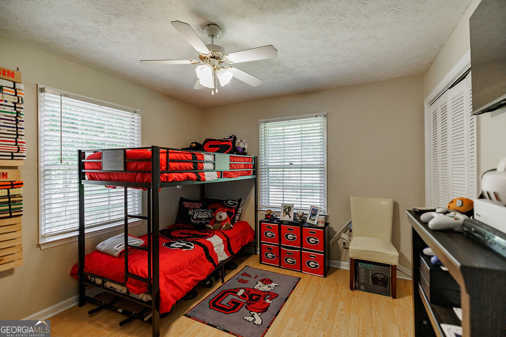 226 Baker Street Statham, GA 30666 - Photo 19 of 55 a bedroom with a bed and a chandelier