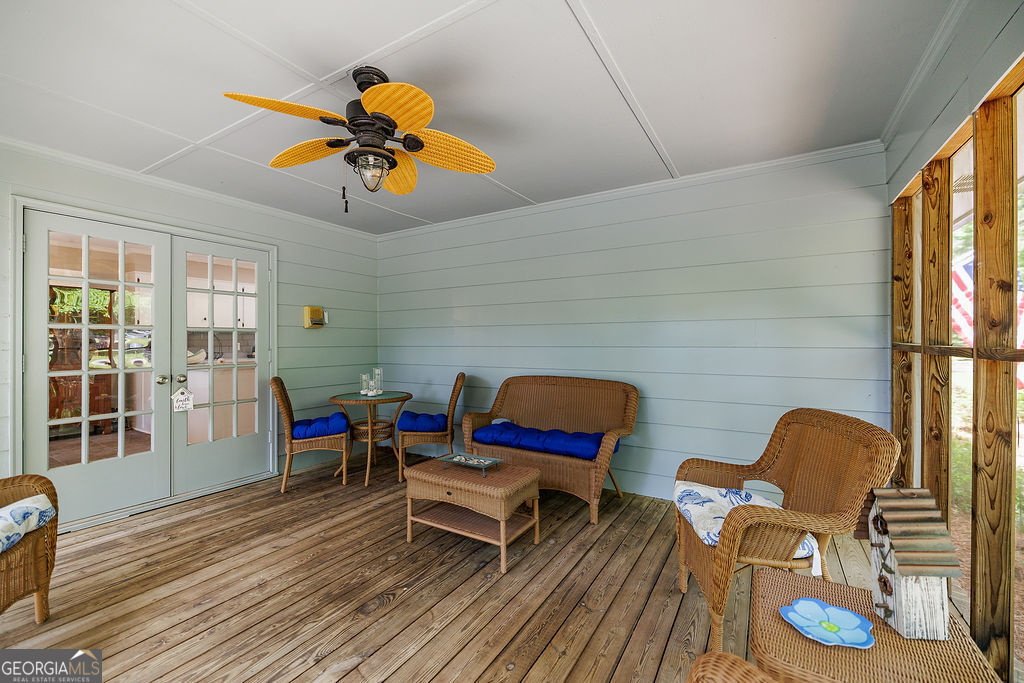 226 Baker Street Statham, GA 30666 - Photo 23 of 55 a living room with furniture a rug and a floor to ceiling window