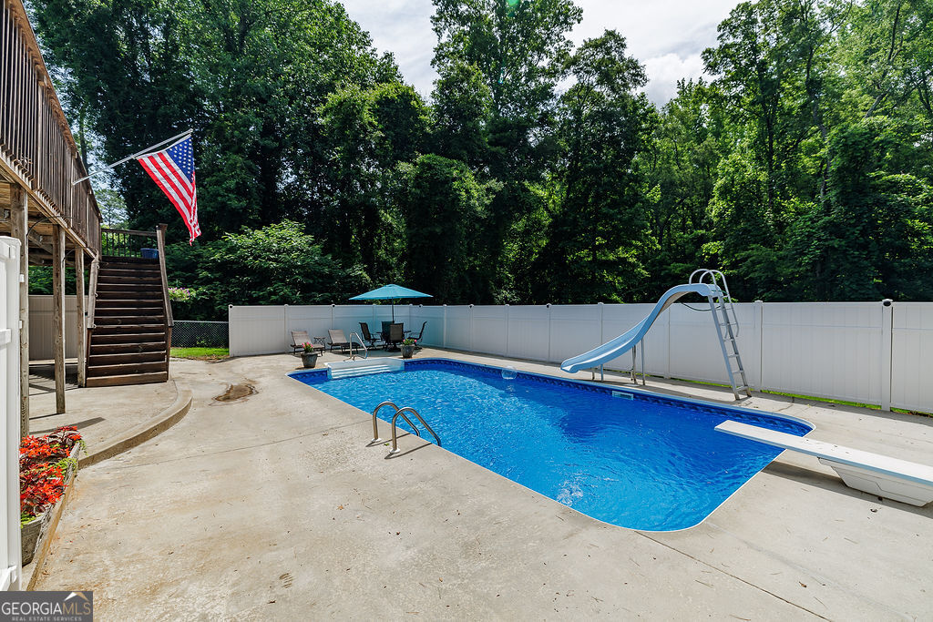 226 Baker Street Statham, GA 30666 - Photo 40 of 55 a roof deck with table and chairs and potted plants