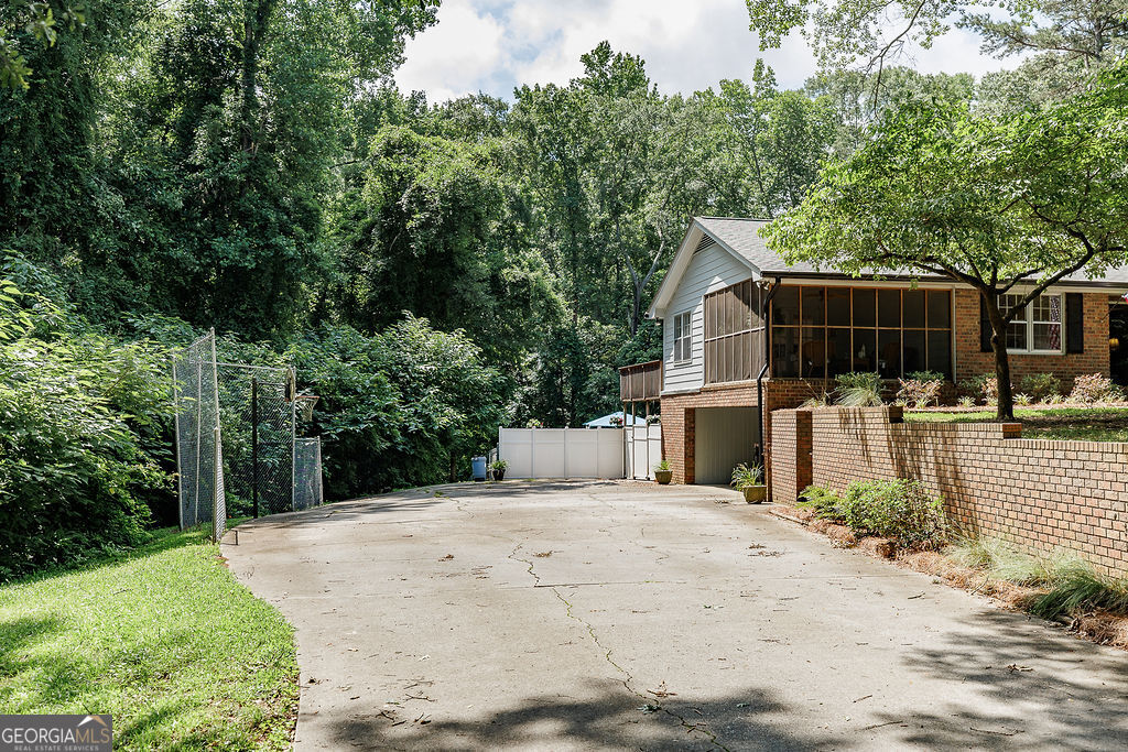 226 Baker Street Statham, GA 30666 - Photo 48 of 55 a view of a backyard with large trees and wooden fence