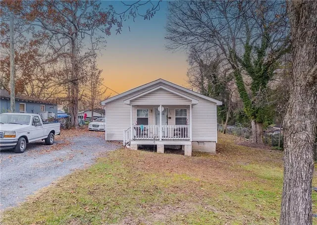 a view of a house with a yard covered in snow