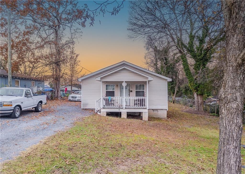 a view of a house with a yard covered in snow