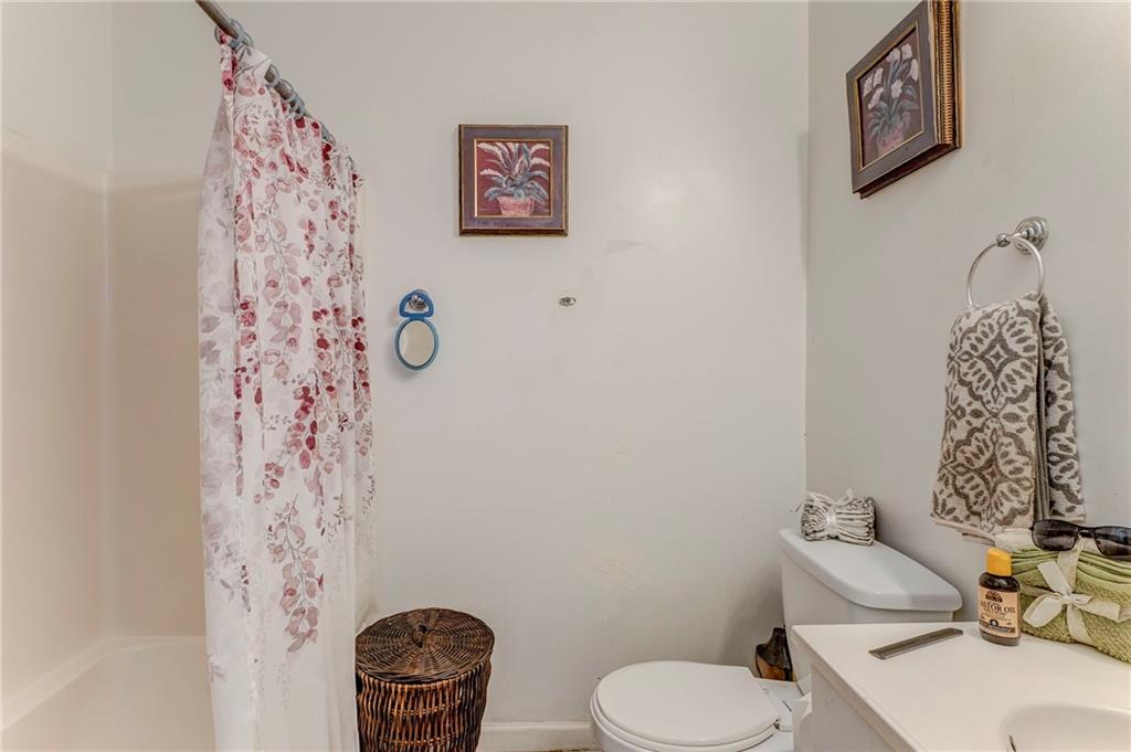 213 Iron Street Northwest Rome, GA 30165 - Photo 12 of 28 a bathroom with a toilet sink and mirror