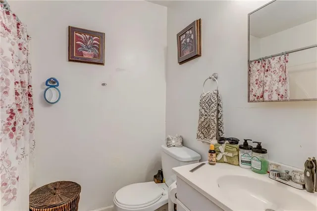 a bathroom with a toilet sink and mirror