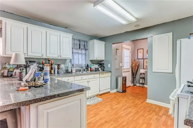 a kitchen with stainless steel appliances granite countertop a refrigerator sink and cabinets