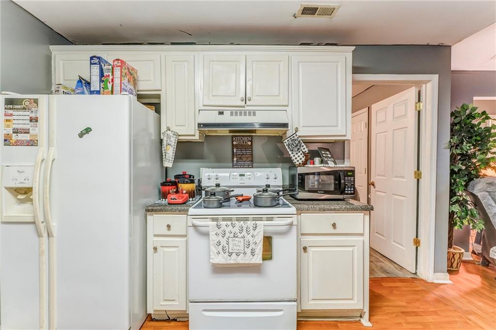 213 Iron Street Northwest Rome, GA 30165 - Photo 16 of 28 a kitchen with stainless steel appliances a stove and refrigerator
