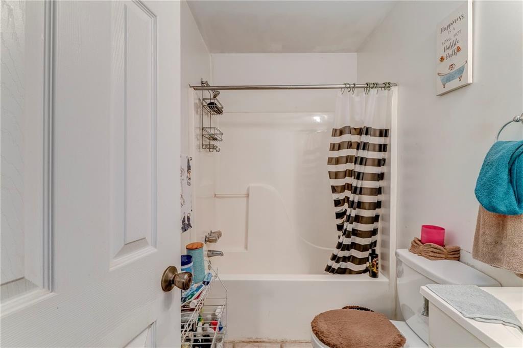 213 Iron Street Northwest Rome, GA 30165 - Photo 23 of 28 a bathroom with a shower a toilet and a shower